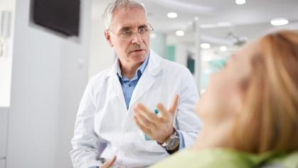 Dentist speaking with patient